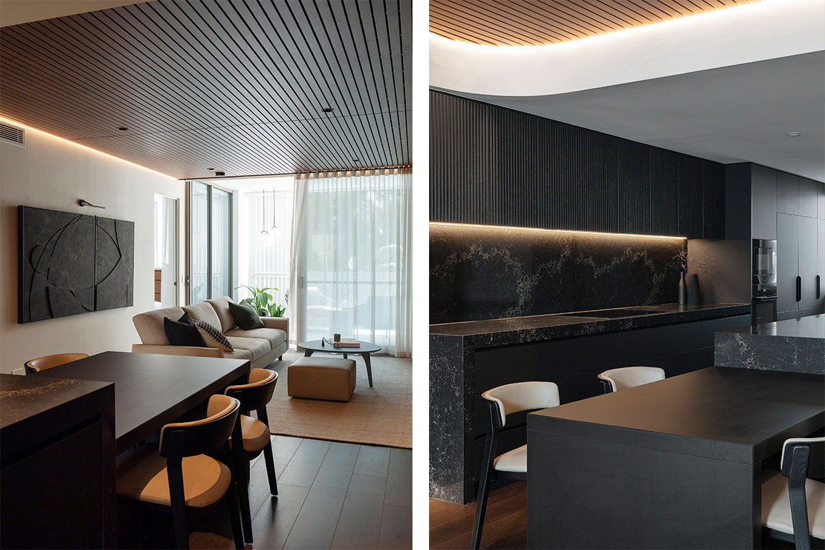 Modern minimalist dining and living area featuring sleek dark interiors and soft lighting.